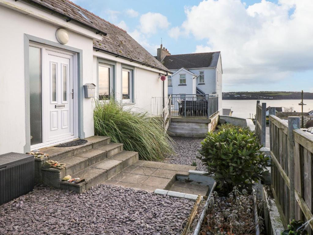 a house with stairs leading to the front door at Oakdene in Milford Haven