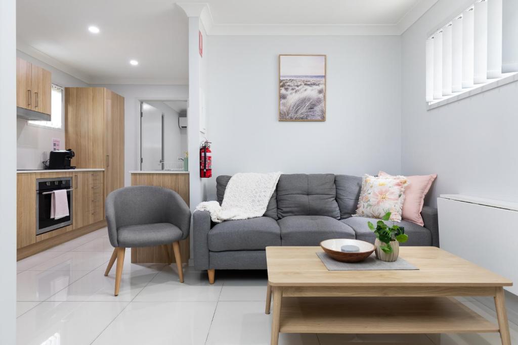 a living room with a couch and a table at Super Host and New Listing in Brisbane