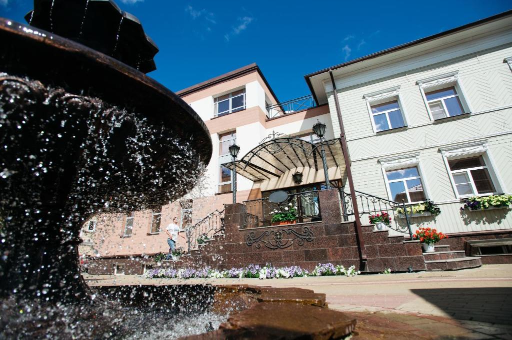 a water fountain in front of a building at History Hotel in Vologda