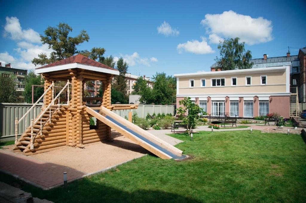 a playground in a yard with a slide at History Hotel in Vologda