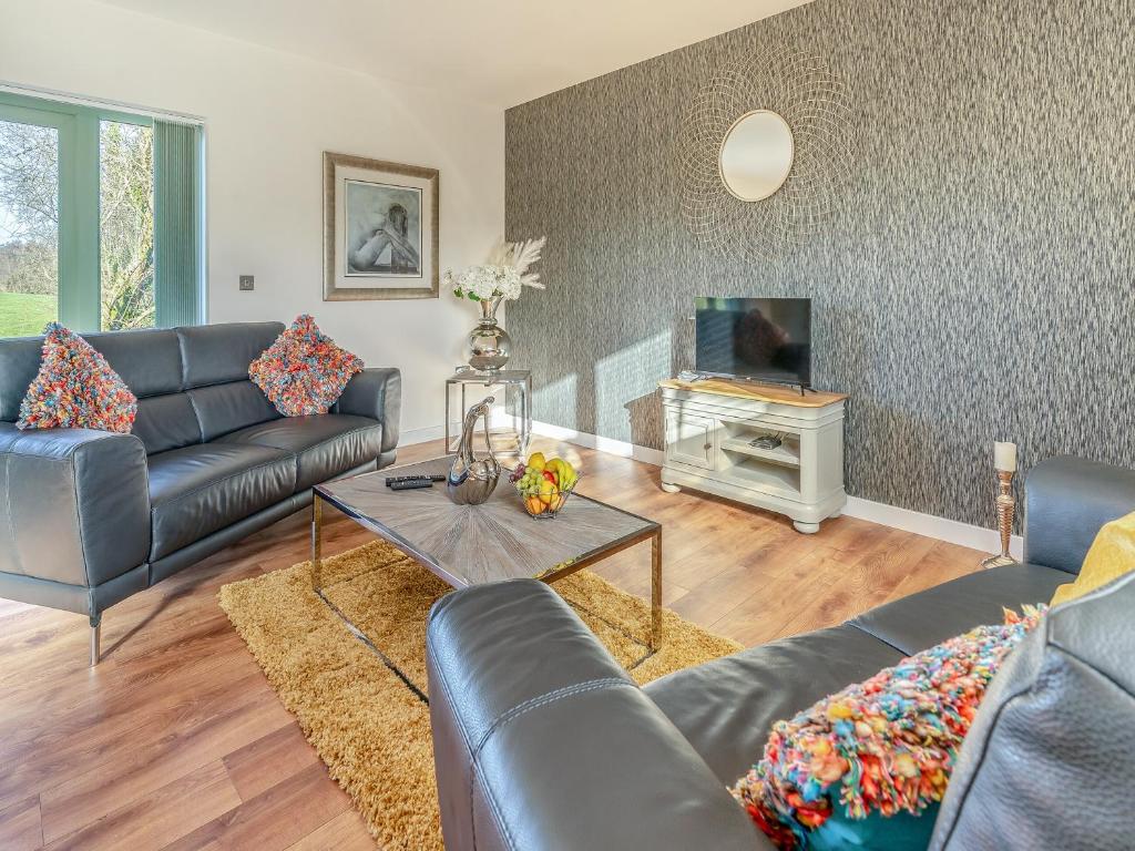 a living room with a couch and a fireplace at Fox Acre - Uk46236 in Usk