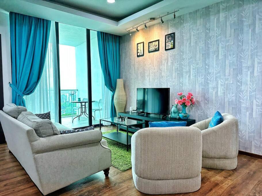 a living room with two chairs and a television at YM Homestay Vivacity megamall Jazz Suite 3 bedroom 8 pax in Kuching