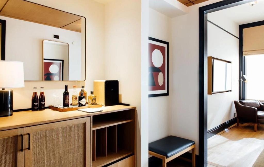 a room with a vanity with a mirror and a chair at Shinola Hotel in Detroit