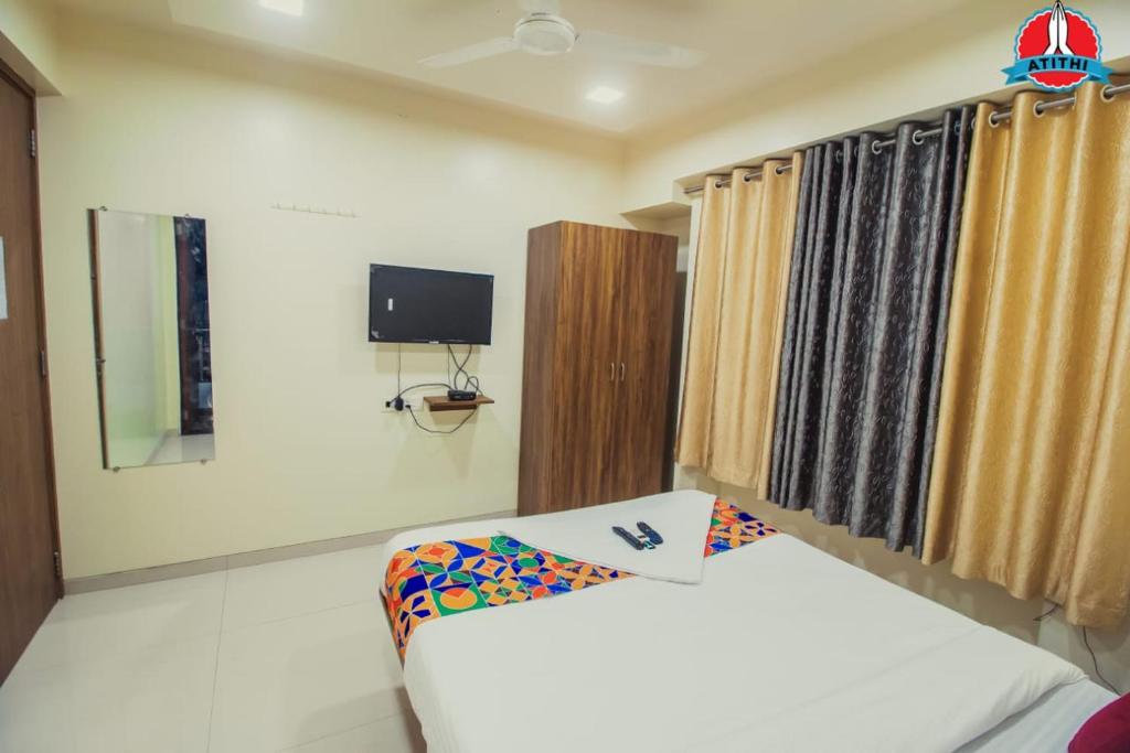 Postel nebo postele na pokoji v ubytování Atithi Service Apartment