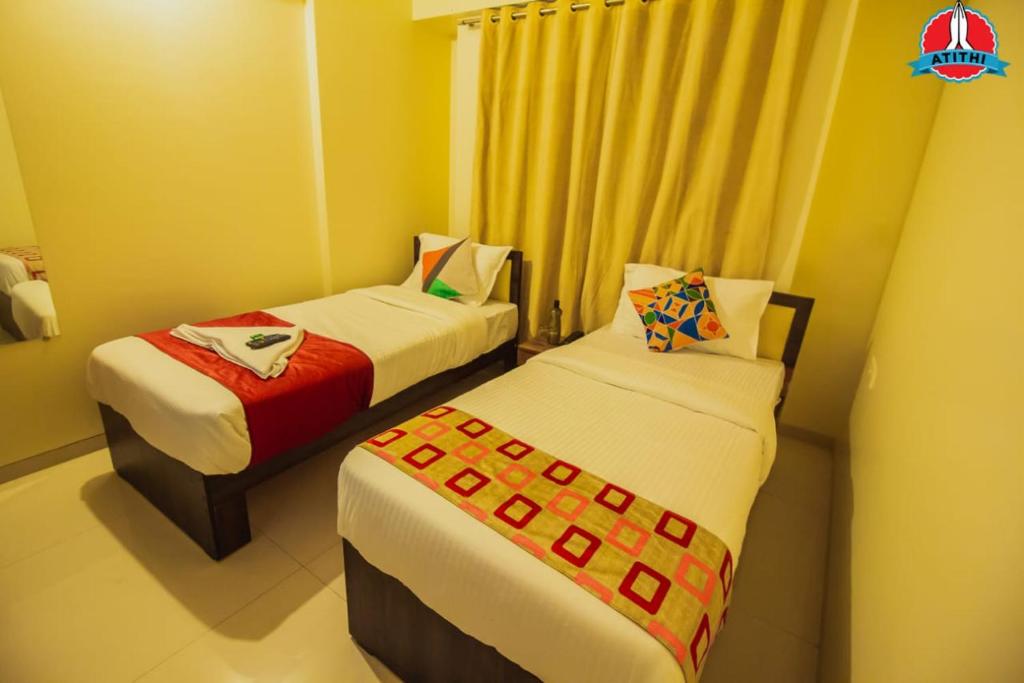 Postel nebo postele na pokoji v ubytování Atithi Service Apartment