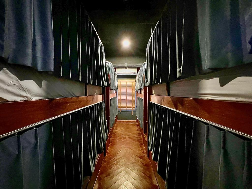 a room with two bunk beds on a boat at Suneta Hostel Chiangmai in Chiang Mai