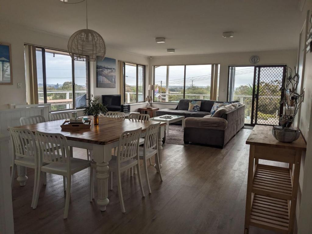 a living room with a table and chairs and a couch at The Castle - Goolwa Beach in Goolwa South
