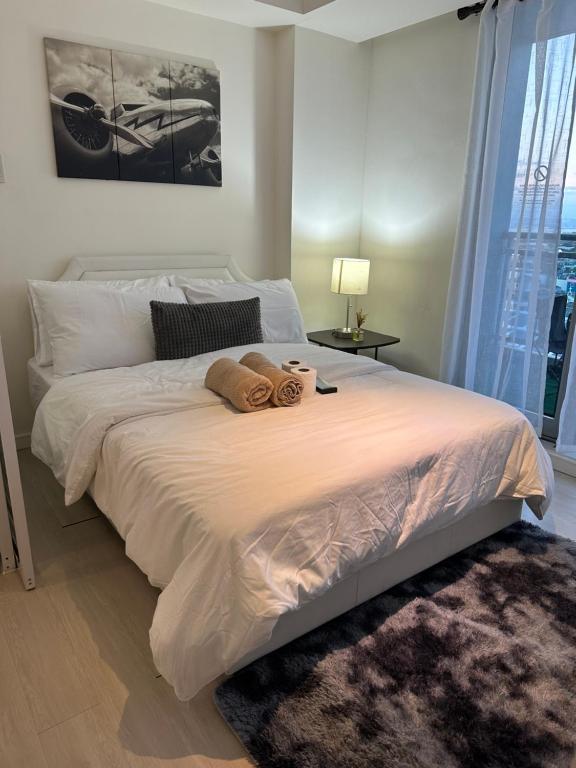 マニラにあるC&J Staycation by Azureのベッドルーム1室(ベッド1台、タオル2枚付)