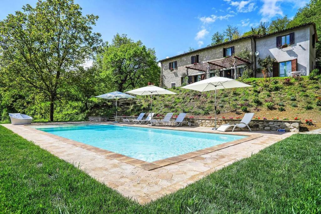 a swimming pool in the yard of a house at Casale Armonia in Massa Martana