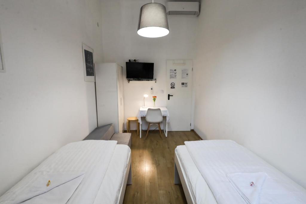 a hospital room with two beds and a table at Pest-port apartment 4 rooms for 16 person in Budapest