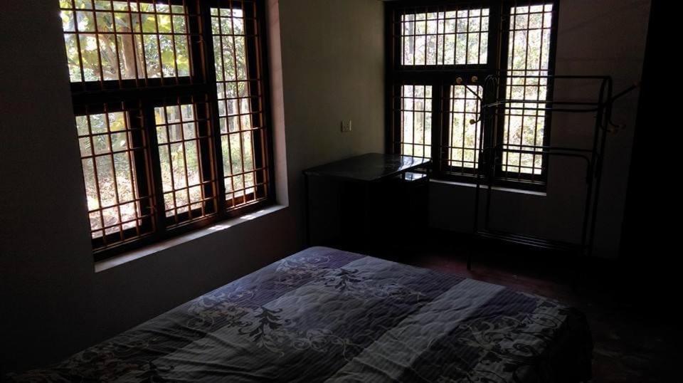 En eller flere senge i et værelse på Nakshakthra Bungalow
