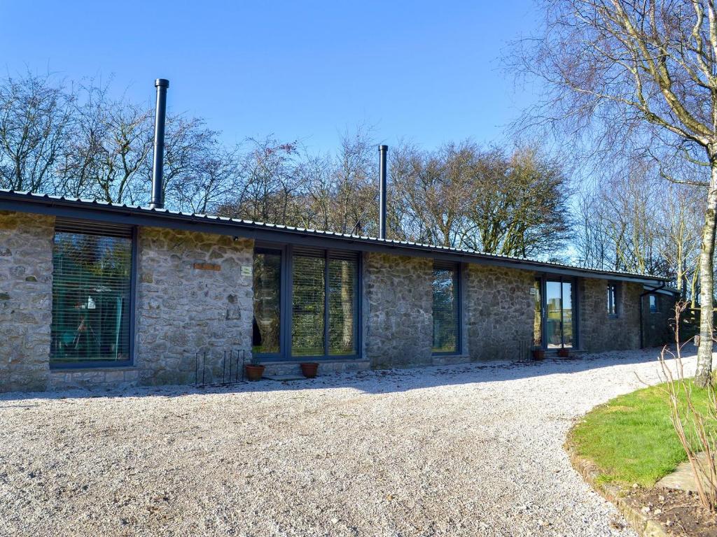 a stone house with windows on the side of it at The Stables - Uk13658 in Middleton