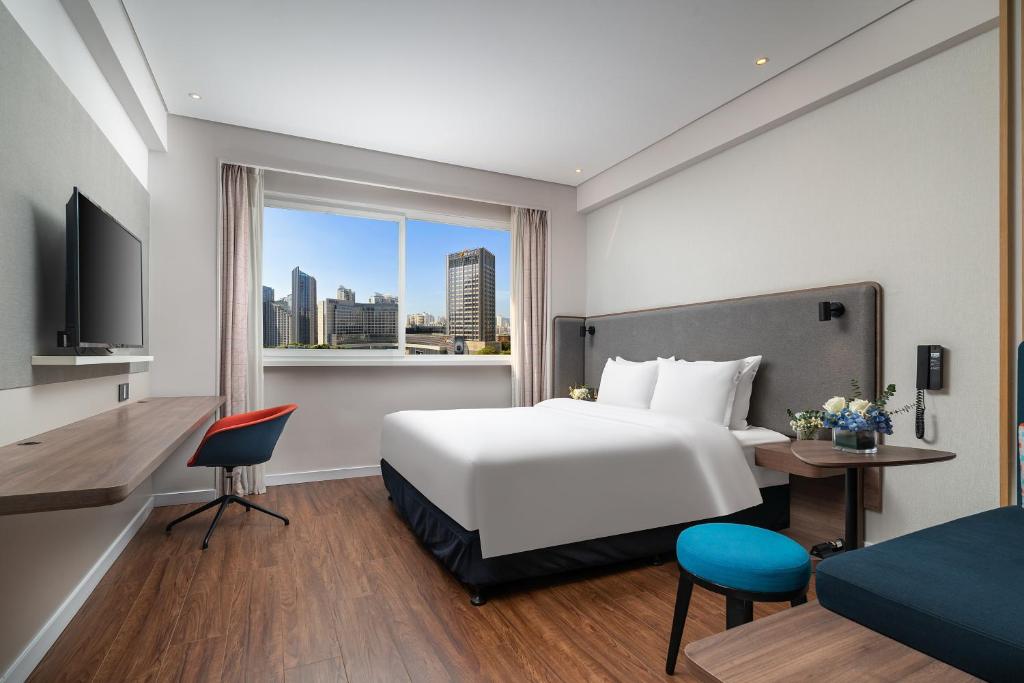 Postel nebo postele na pokoji v ubytování Holiday Inn Express Xiamen Lushan -Shopping Center by IHG