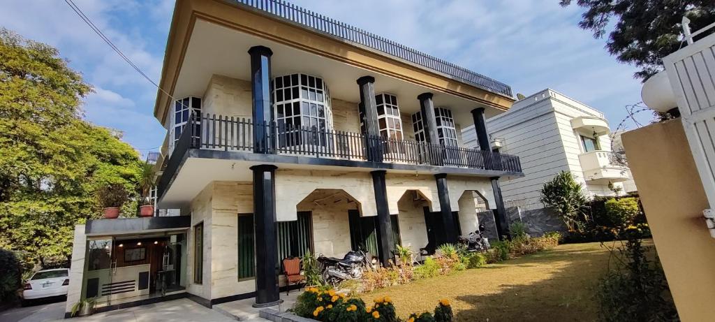 a large white building with a balcony at Capri Executive in Islamabad