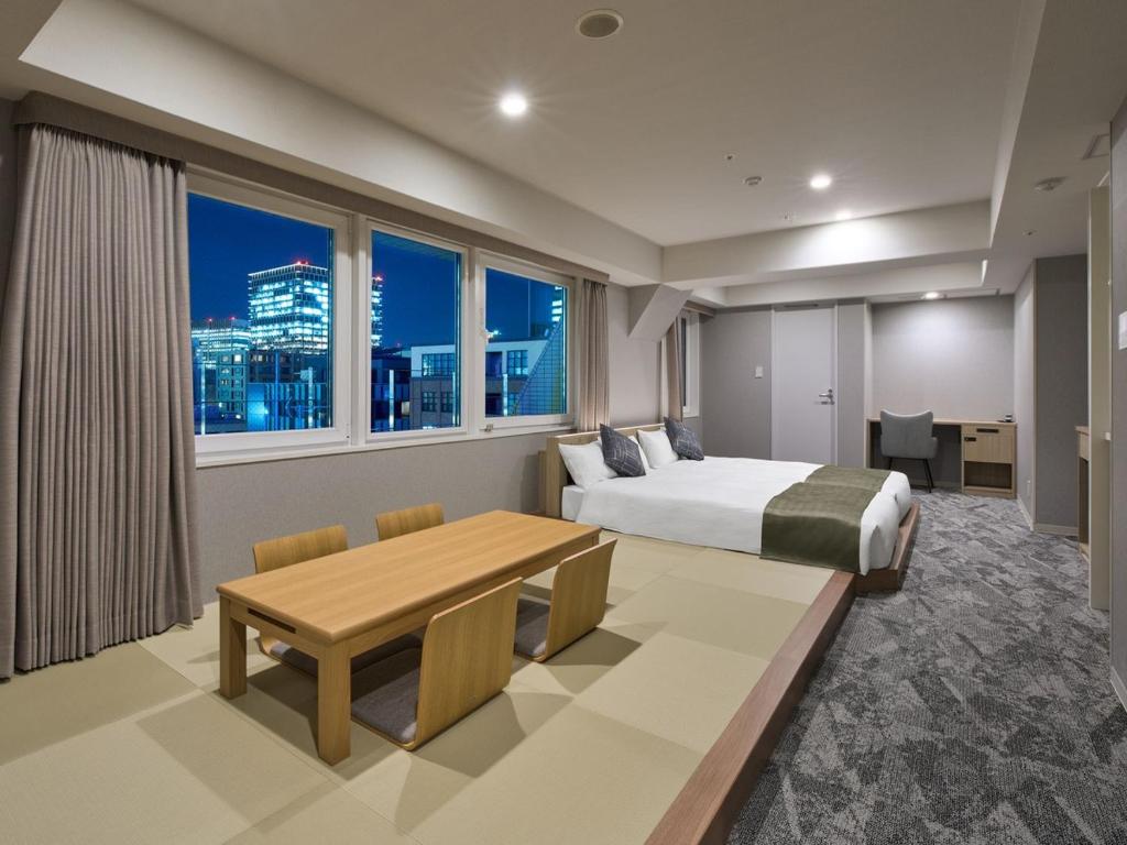 um quarto com uma cama, uma secretária e uma mesa em Hotel Villa Fontaine Tokyo-Otemachi em Tóquio