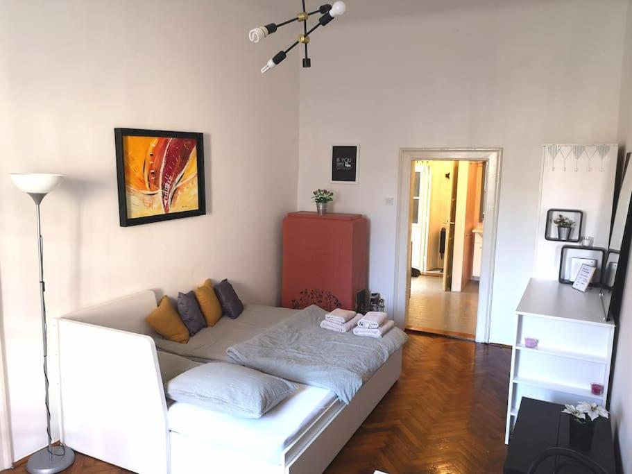 a living room with a white couch in a room at Cosy condo in the heart of the Upper town Zagreb in Zagreb