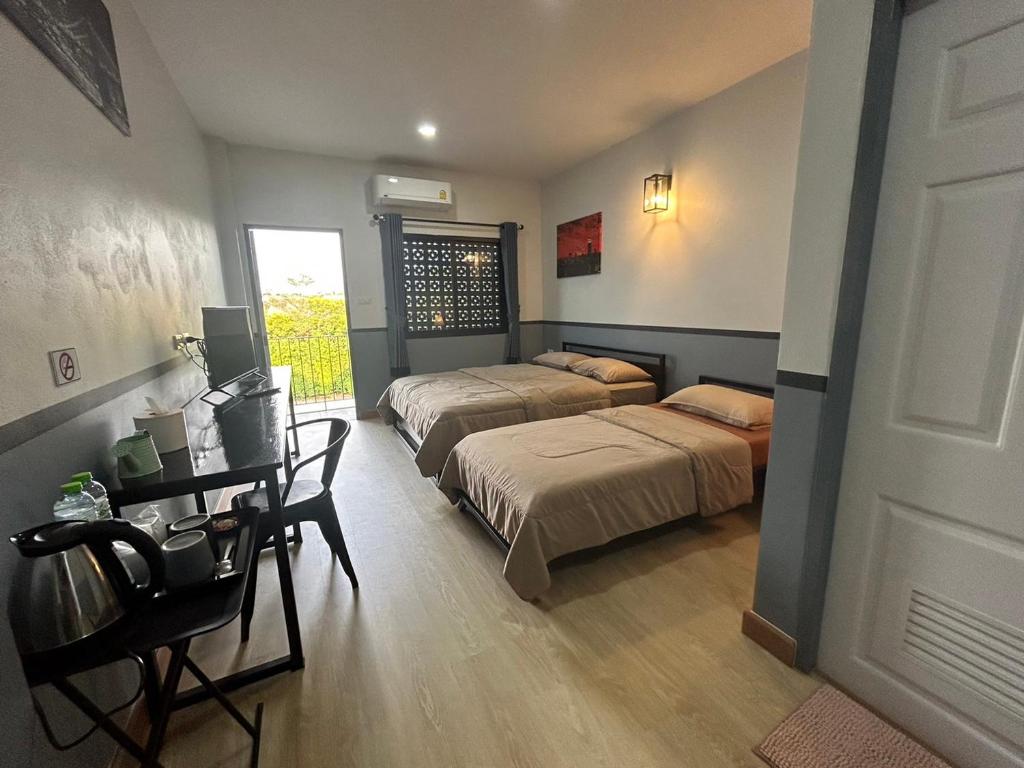 Postel nebo postele na pokoji v ubytování บ้านสุขซอย5