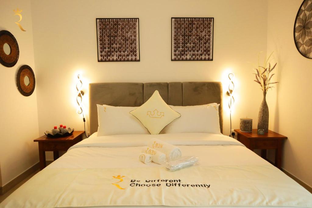 a bedroom with a bed with two towels on it at Twilight 1BR apartment Yas Island in Abu Dhabi