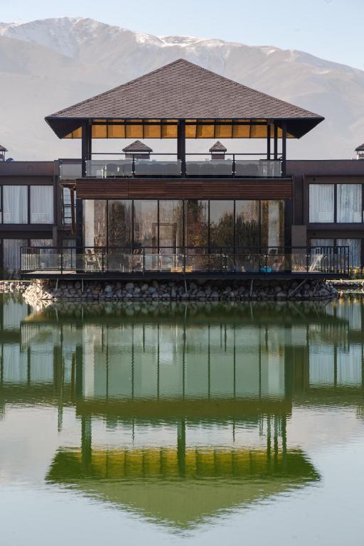 a house on a pier next to a body of water at Arman Dala Resort in Qaskeleng