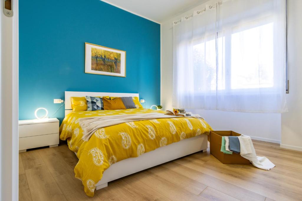 a blue bedroom with a bed with a yellow bedspread at [Arona Centro] Blue Lake - Wi-Fi in Arona