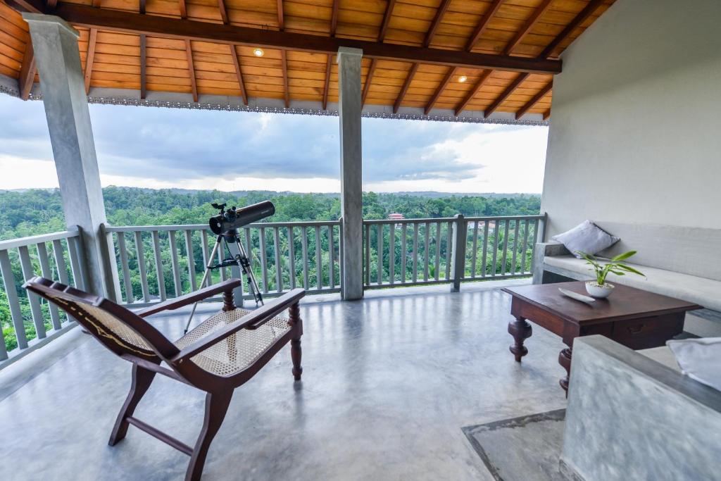 a room with a view of a balcony with a camera at The Horizon Hill Top Villa in Unawatuna