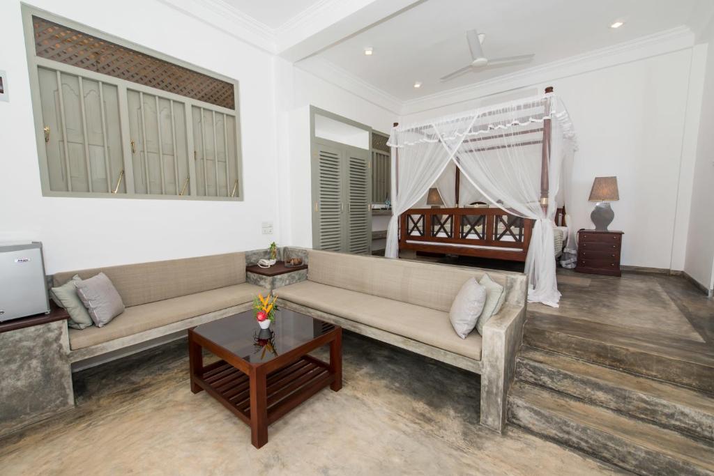 a living room with a couch and a bed at The Horizon Hill Top Villa in Unawatuna
