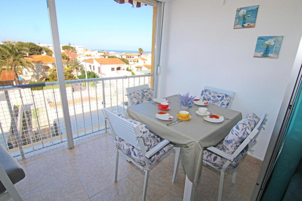 a table and chairs on a balcony with a view at Santa Ana in Denia