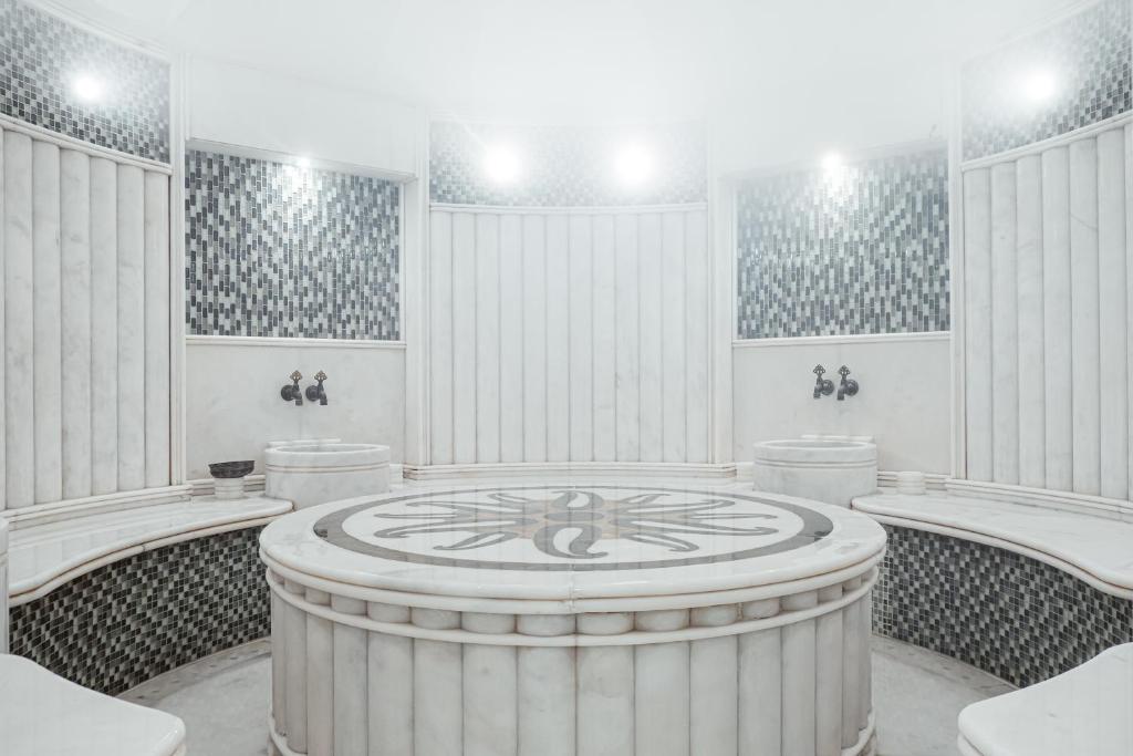 a large white room with a large clock in the middle at FLY INN BAKU in Baku
