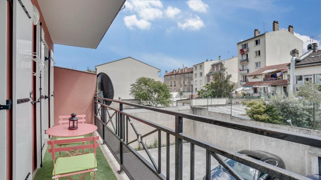 a balcony with a view of a street and buildings at Chic apart with parking and balcony near Paris in Aubervilliers