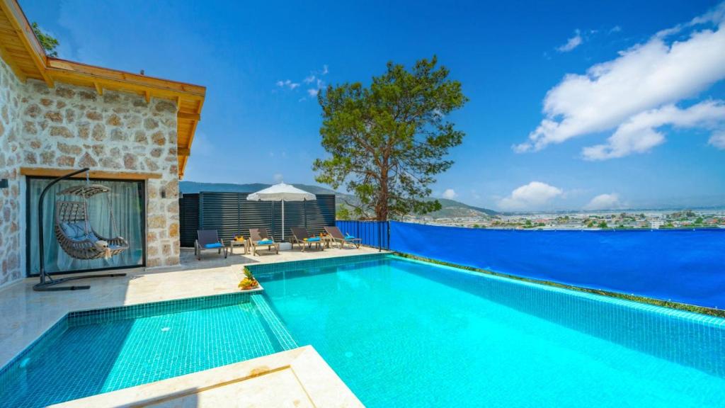 a swimming pool with a view of the water at Villa Nazlısu in Kaş