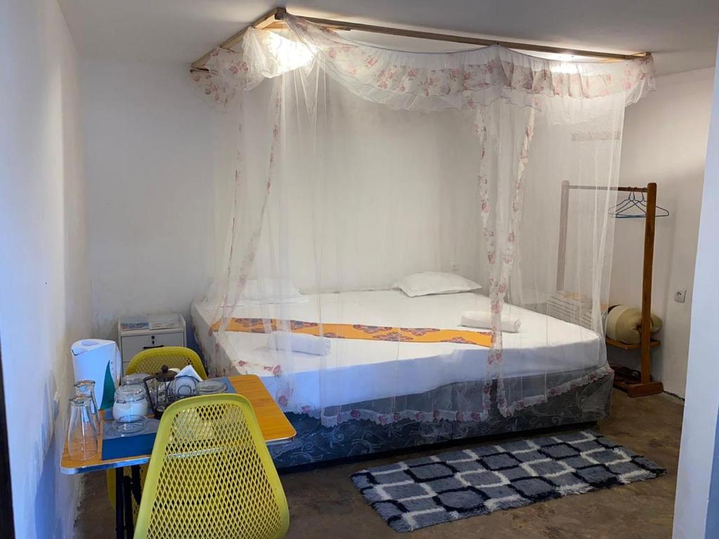 a bedroom with a bed with a canopy at Aeropark Residencial (B&B) in Maputo