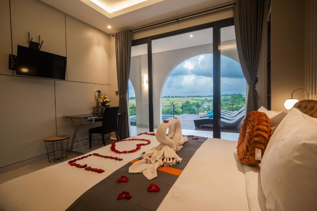 a bedroom with a bed with red flowers on the floor at Alsava Villa and Suites Canggu in Canggu