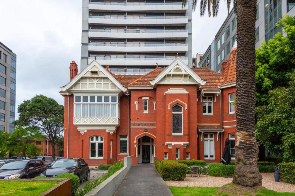 an old red brick building in a city at Well located 1Bed Unit in near Albert Park w Gym! in Melbourne