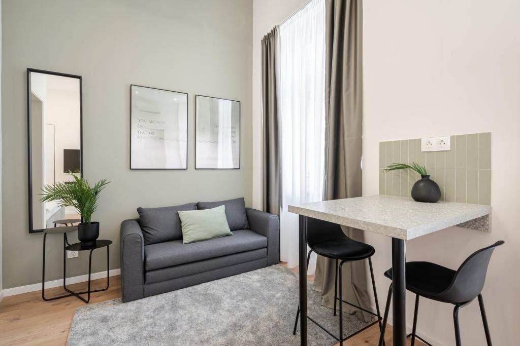 een woonkamer met een bank en een tafel bij K27- Boutique Apartments, Best Location, by BQA in Boedapest