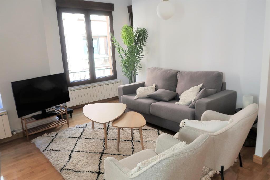 uma sala de estar com um sofá e uma mesa em Bonito piso a 500m de la Catedral em León
