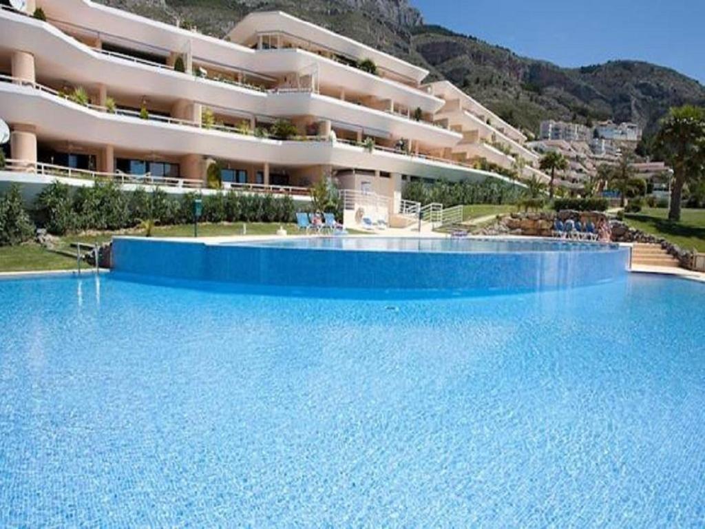 a large swimming pool in front of a building at Ashanti Bay Luxury Golf Apartment in Altea
