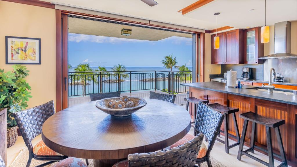a kitchen and dining room with a table and chairs at Ko Olina Beach Villas B410 in Kapolei