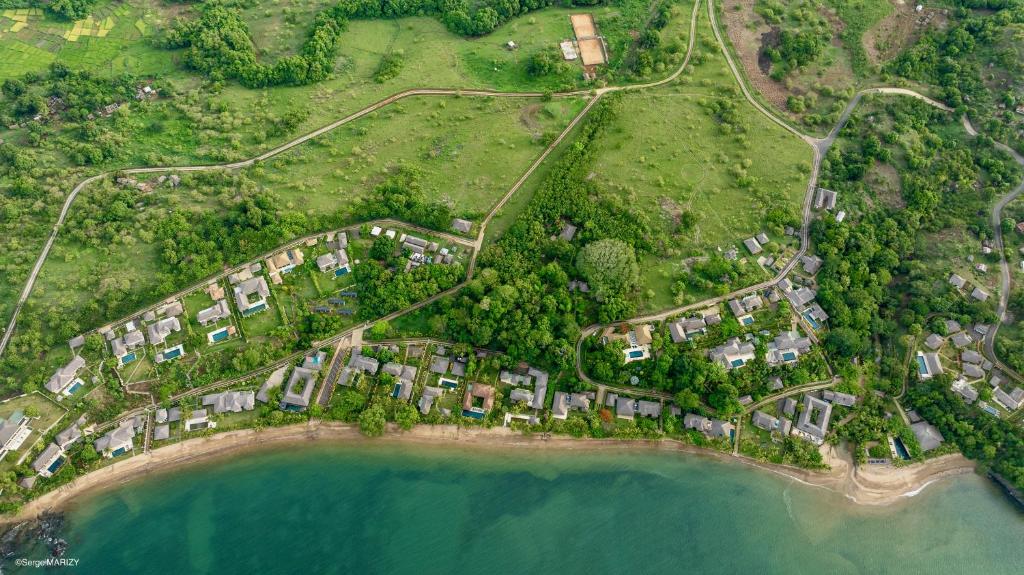 an aerial view of a resort near the water at Home The Residence in Befotaka Bay