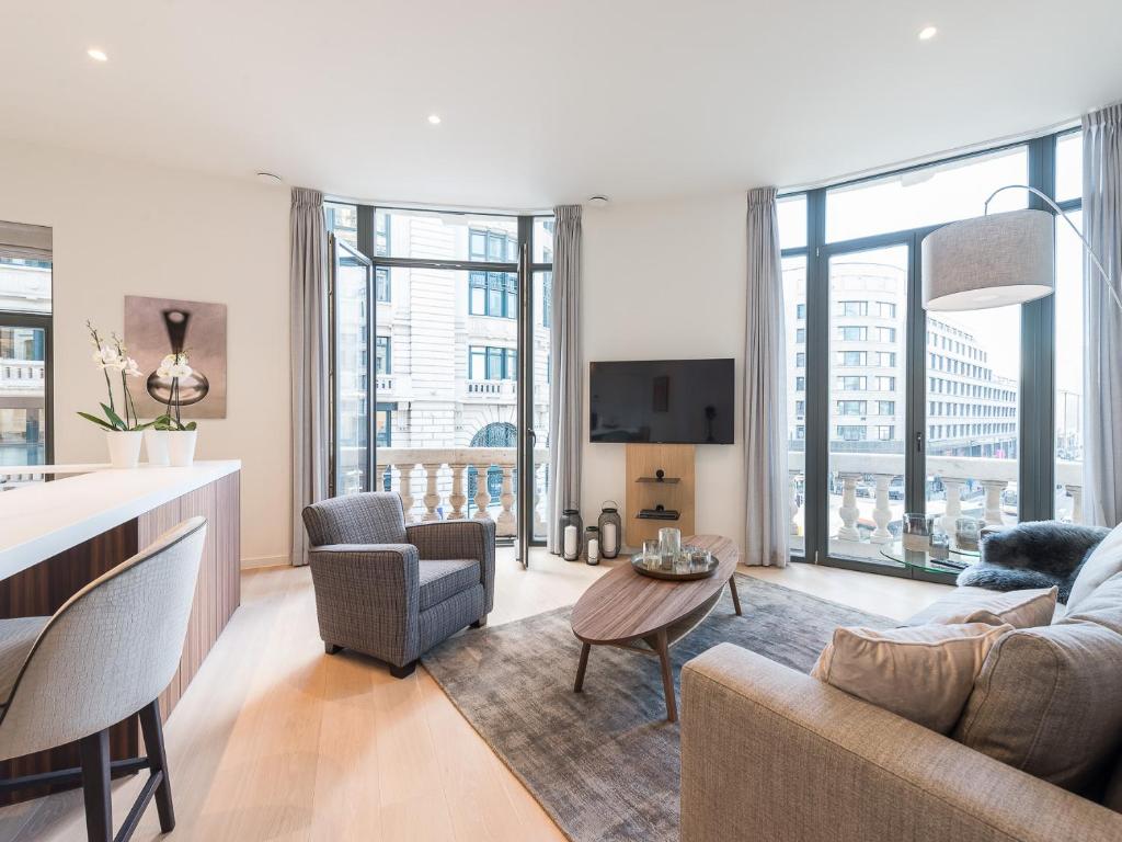 a living room with a couch and a table at Brussels Splendor Suites in Brussels