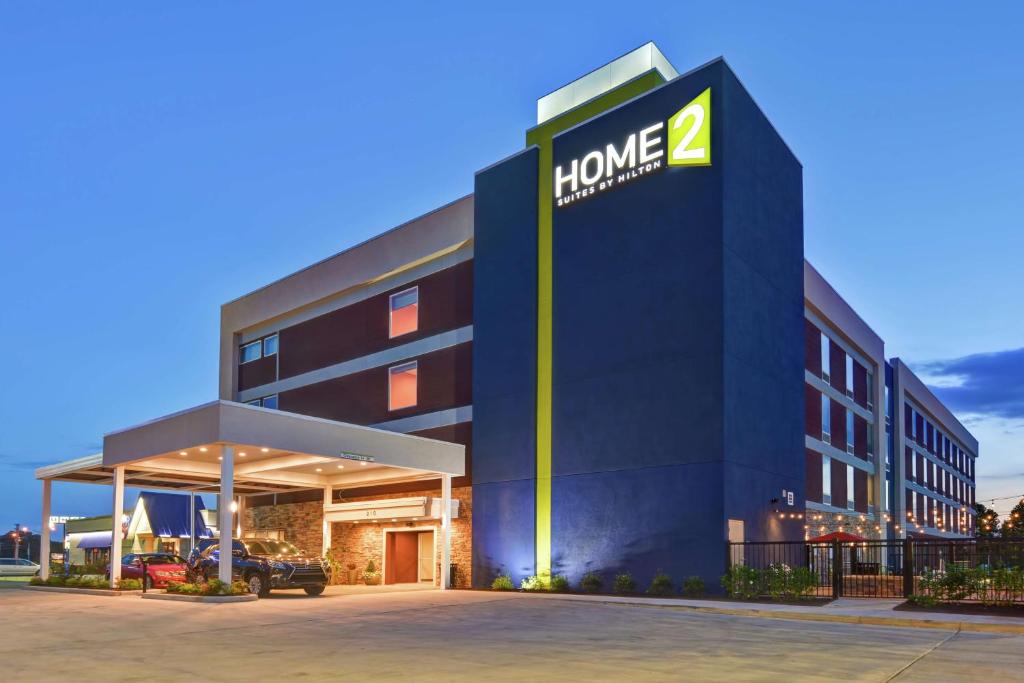 a building with a sign on the side of it at Home2 Suites By Hilton Meridian in Meridian