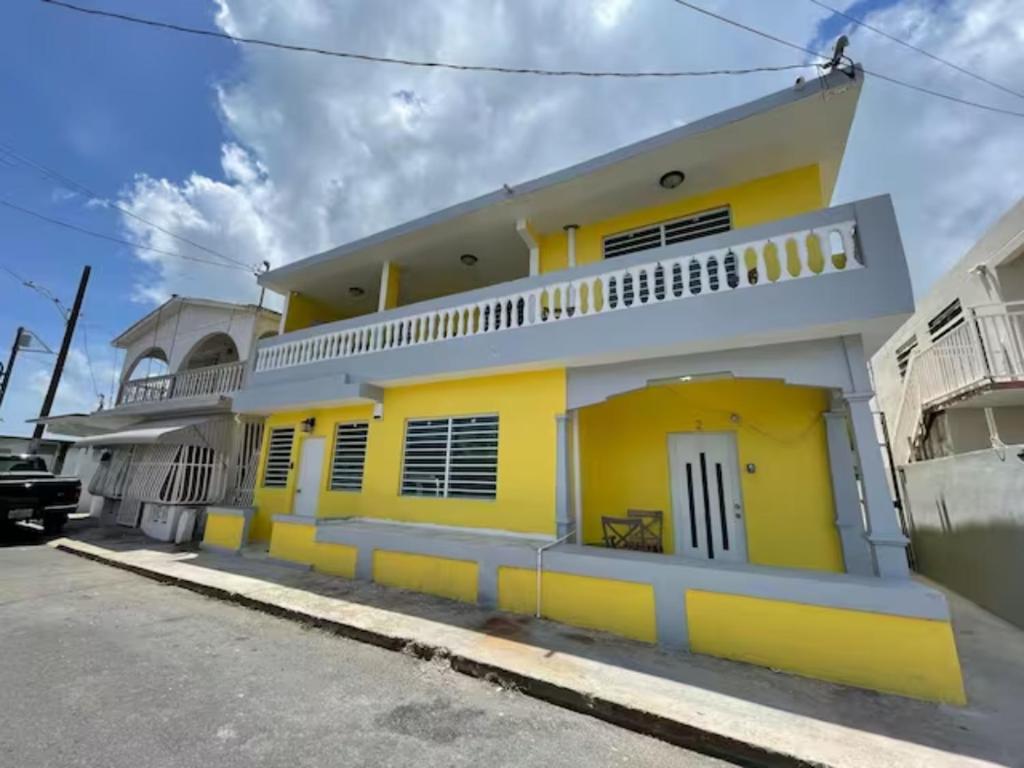 a yellow house with a white and yellow at One BR Studio Just few Steps to the Ocean in a Fishing Village, Unit 2 in Catano