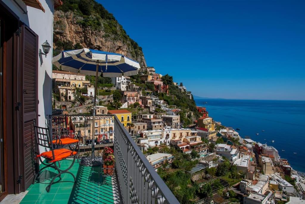 a balcony with an umbrella on top of a mountain at M'incanto in Positano