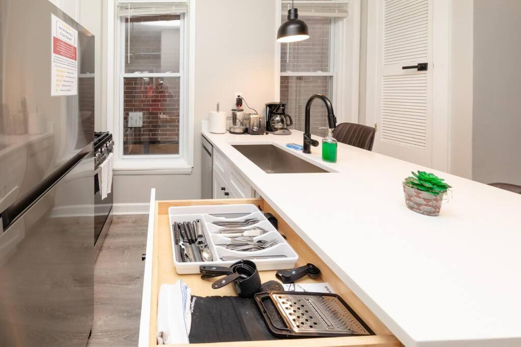 a kitchen with a counter with a stove top oven at The Secret West Loop Oasis in Chicago