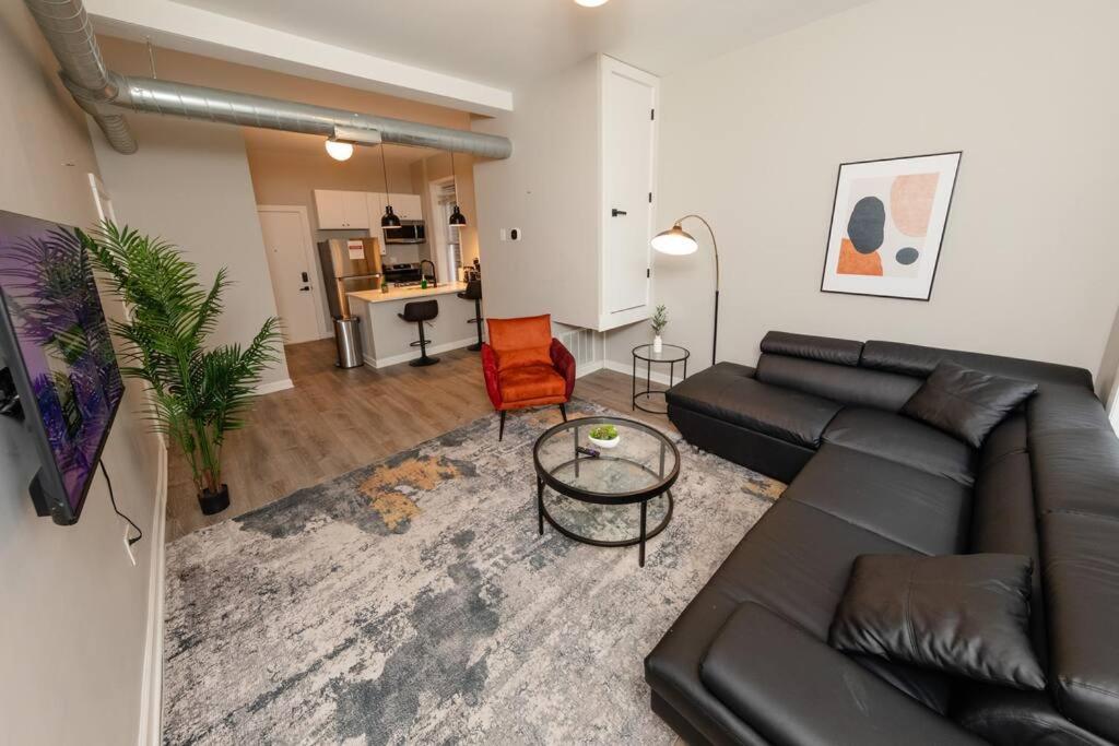 a living room with a black couch and a table at The Secret West Loop Oasis in Chicago