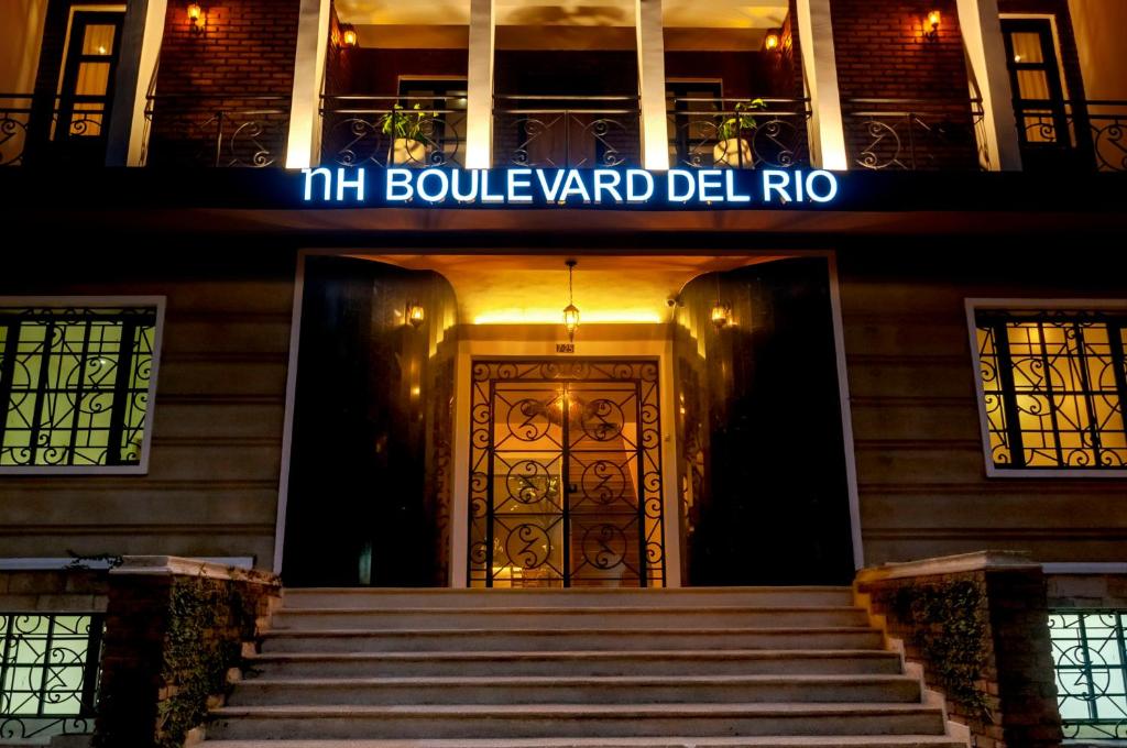 a front door of a building at night at NH Boulevard del Río Cali in Cali