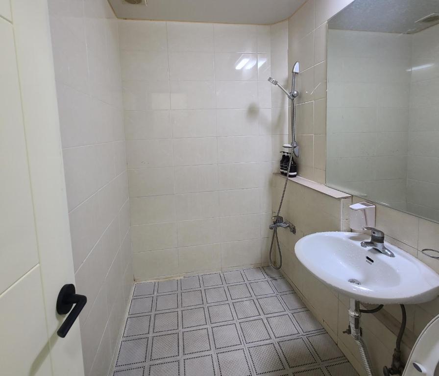 a small bathroom with a sink and a shower at Danggum Stay in Suncheon