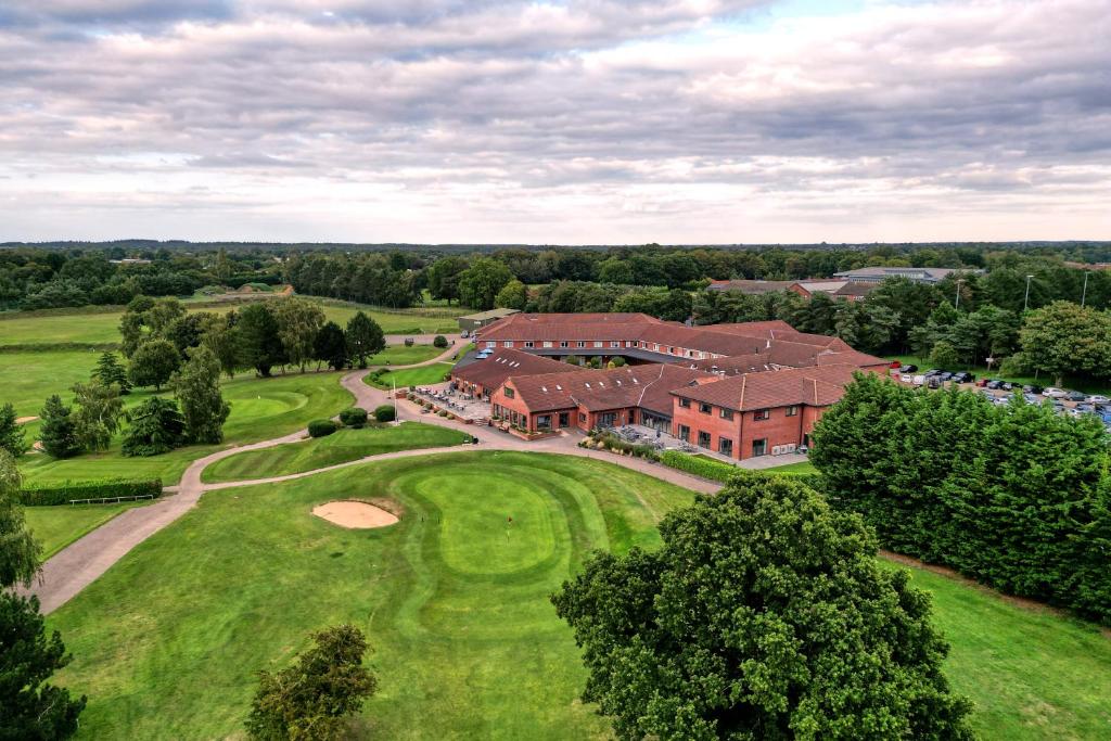 una vista aérea de una casa grande con campo de golf en Wensum Valley Hotel Golf and Country Club en Norwich