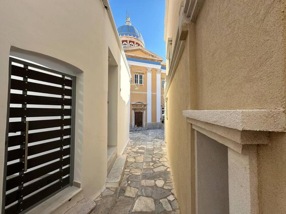 a building with a gate on the side of a street at Fouli,Syros Apartment,Ermoupoli in Ermoupoli