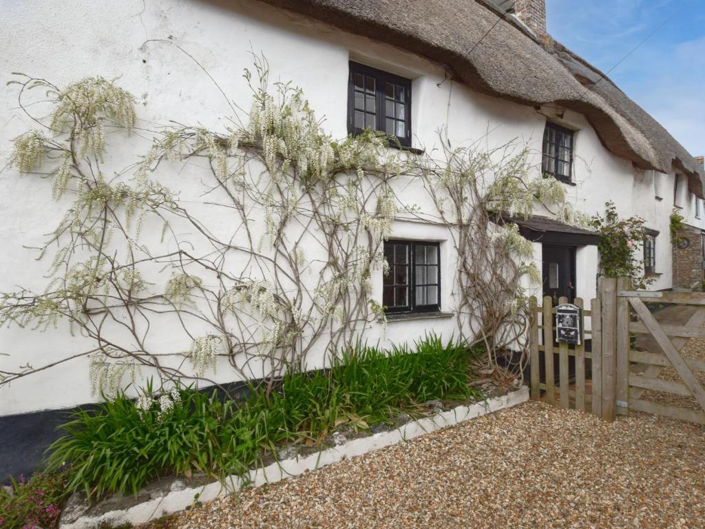a thatched cottage with a gate and a fence at 3 Bed in Salcombe 75138 in Bigbury