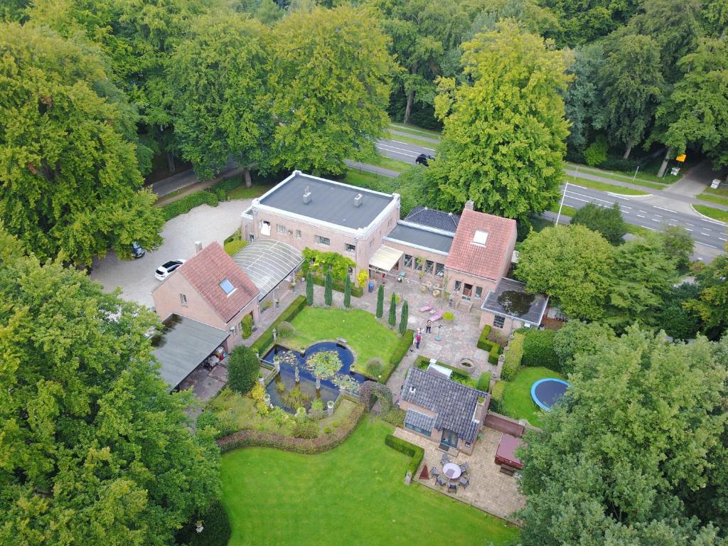 an aerial view of a large house with a garden at Londons Cottage in Hilversum